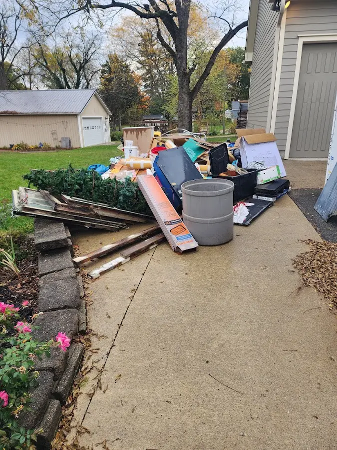 Dumpster being loaded with debris for Commercial Dumpster Rental in Huntsville